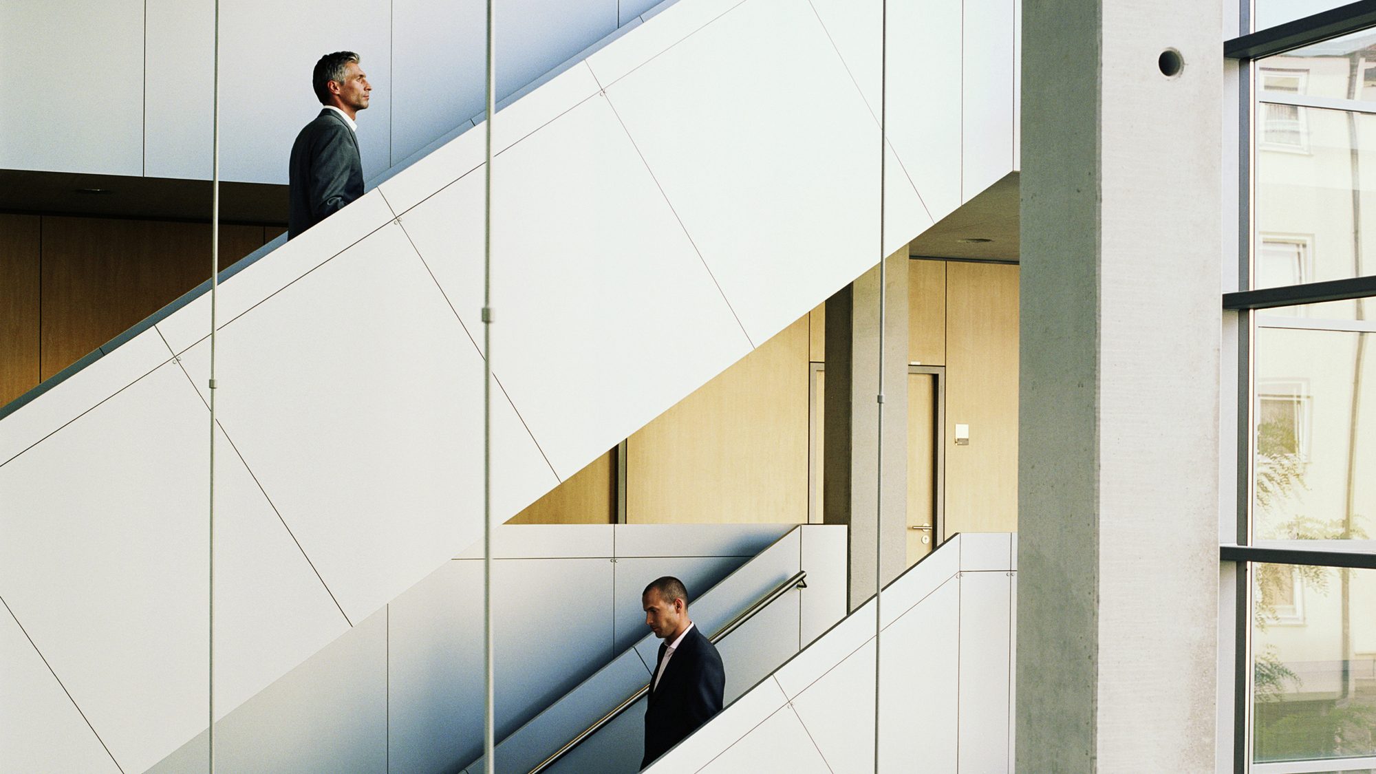 [Corporate executives] Two businessmen on stairss